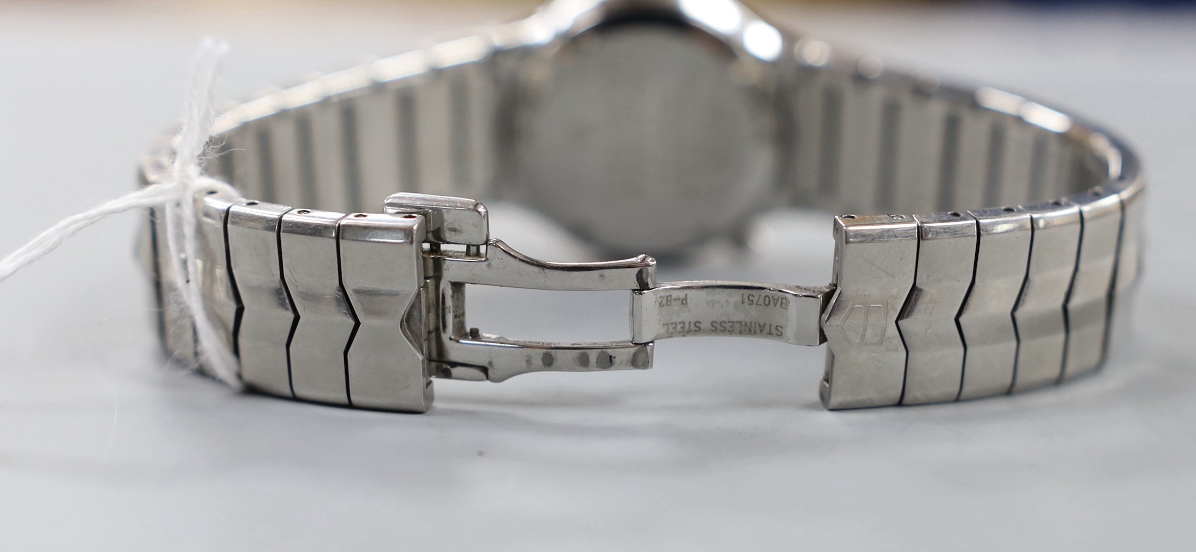 A lady's stylish modern steel Tag Heuer quartz wrist watch and bracelet, with blue dial and diamond chip set bezel, with boxes.